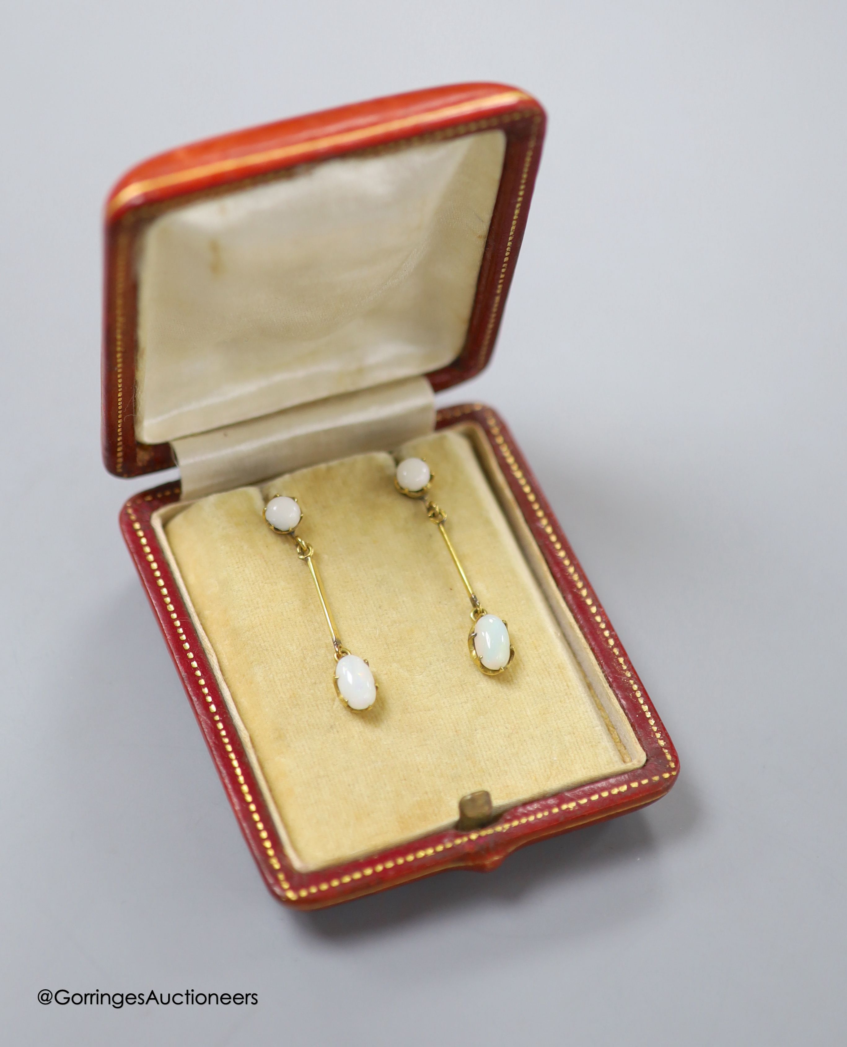 A pair of 9ct and two stone white opal set drop earrings, 36mm, gross 2.9 grams (one of the appears to be a replaced simulated opal which is also chipped).